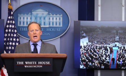 Sean Spicer delivers a statement on 21 January 2017 while a television screen shows a picture of Trump’s inauguration.