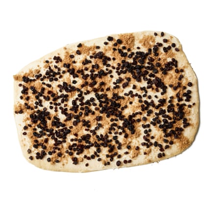 Turn out the dough on to a lightly floured surface, knock back and roll out to a rectangle about 25cm x 35cm, with one of the long sides facing you. Smear the butter on top, then scatter evenly with the sugar and currants (you could use any kind of dried fruit, but chop it to currant size if it’s large).