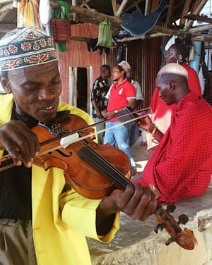 Music for ferry terminals, in Zanzibar. 
A man playing his violin at Forodhani beach, near the Zanzibar ferry terminal in Stone Town, while he waits for the boat to Dar es Salaam, on the Tanzanian mainland.