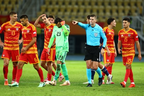 Referee François Letexier points to the spot to award Scotland a penalty.