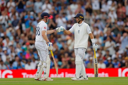 Harry Brook and Joe Root (right) bat during day four of the fifth Test between England and India.