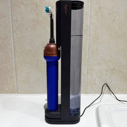 The Dyson CameraJet toothbrush in its dock.