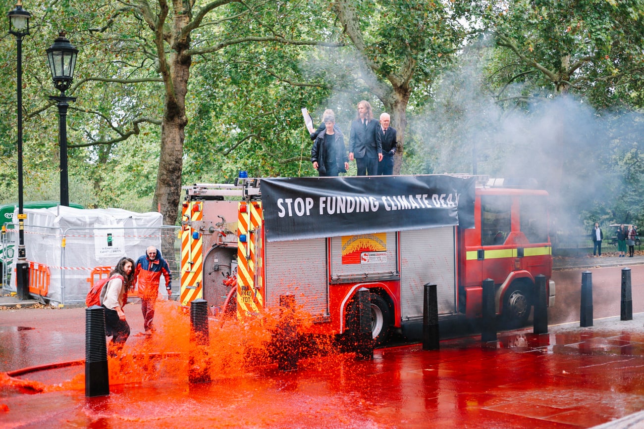 XR activists used an out of commission fire engine to spray fake blood at the Treasury