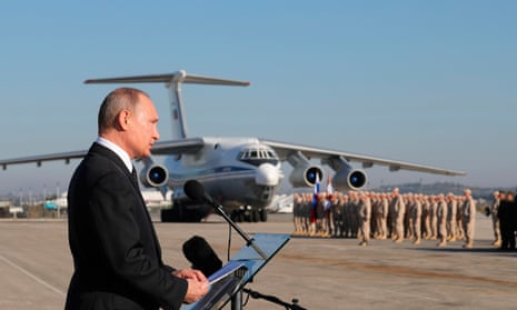 Vladimir Putin addresses Russian troops at an air base in Syria in December 2017.