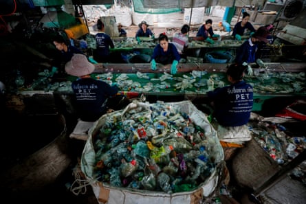 Migrant workers sort through plastic bottles at the Thaiplastic Recycle Group plant in Samut Sakhon, outside Bangkok, Thailand.