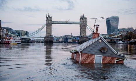 A model house launched by Extinction Rebellion activists floats in the Thames by Tower Bridge, Sunday 10 November.