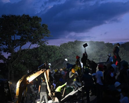 Rescuers and volunteers search for survivors in Cali, Colombia.
