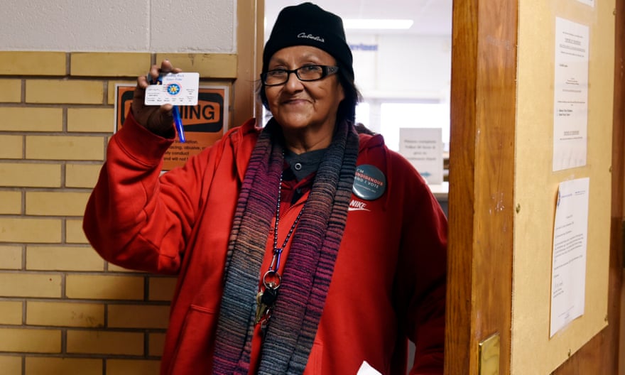 Alva Gabe, who has lived in Standing Rock her whole life and voted in every election since 1984, shows her new tribal ID with a street address, which will allow her to vote in North Dakota.