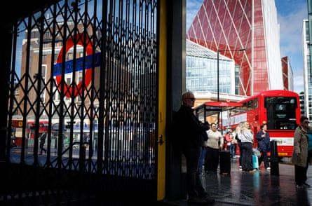 People queue for buses outside a closed tube station during the London Underground strike in September 2025.