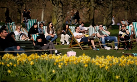 People relax on deck chairs in Hyde park in London, England, as lockdown restrictions were eased.