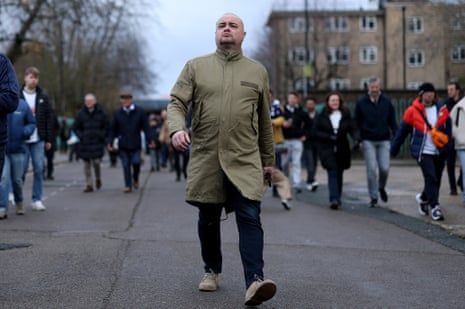 A tottenham fan arrives for the match