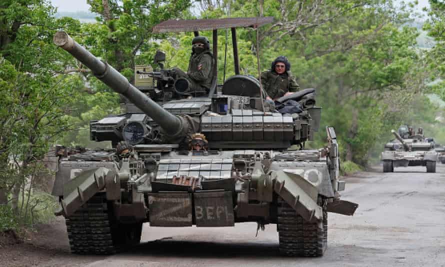 Service members of pro-Russian troops drive a tank in the Donetsk region last month.