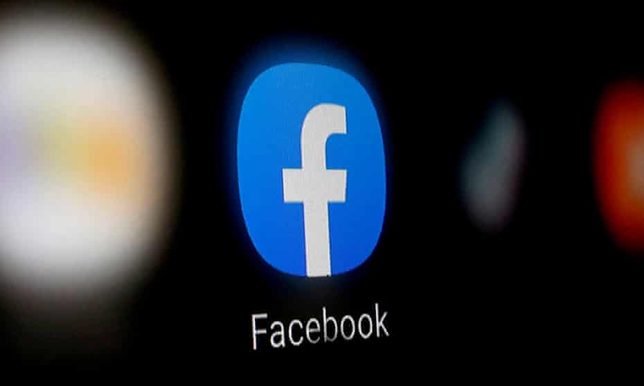 A Facebook logo is displayed on a smartphone