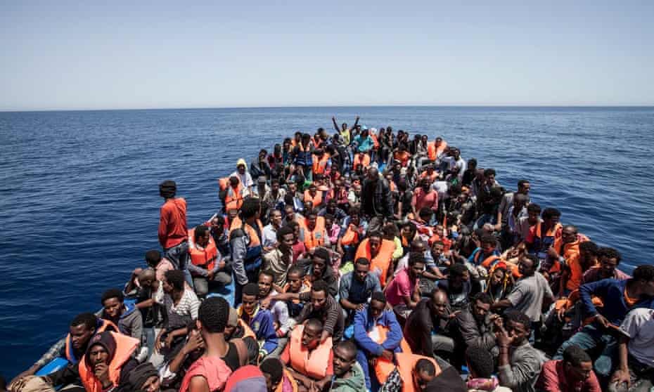 Migrants crowd the deck of their wooden boat off the coast of Libya.