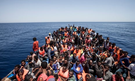 Hundreds of migrants hoping to get to Europe crowd the deck of a boat off the coast of Libya in 2015.