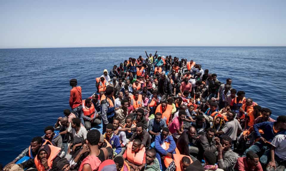 Migrants crowd the deck of a wooden boat off the coast of Libya, May 2015.
