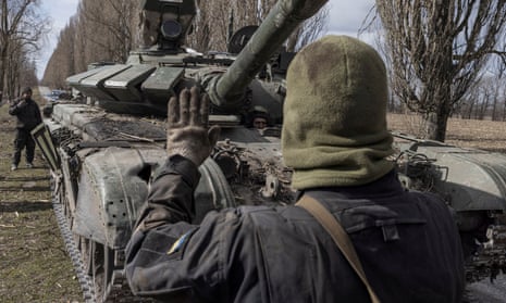 A Ukrainian serviceman walks past a Russian tank captured after fighting with Russian troops in the village of Lukyanivka outside Kyiv, at the weekend.