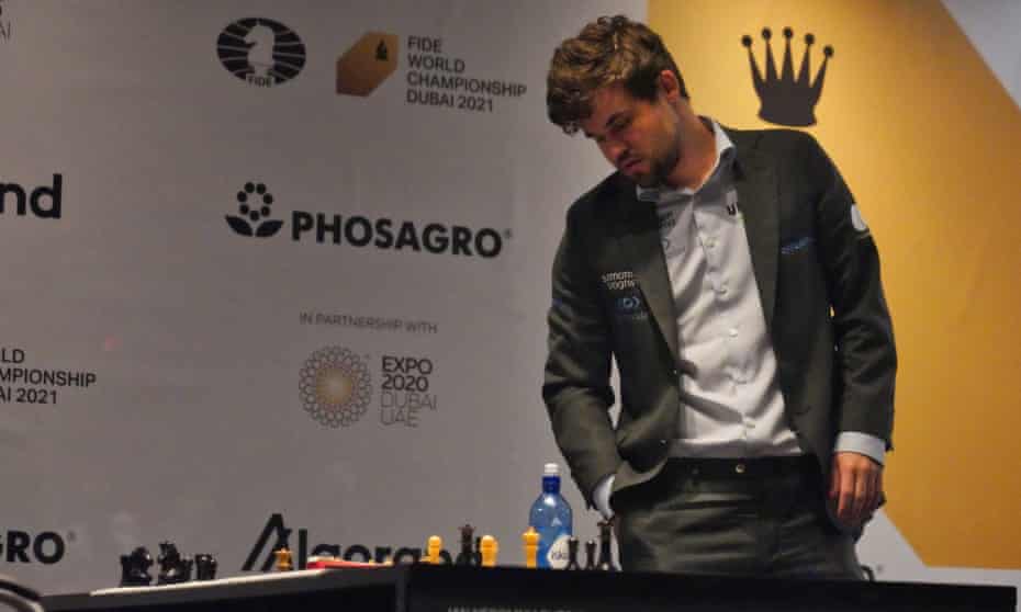 Still the king: Magnus Carlsen surveys the board after completing the defence of his world title.
