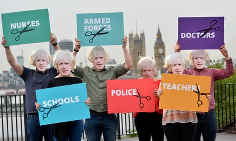 People dressed as Boris Johnson hold placards showing the groups of people that will be affected most by a Tory Brexit.