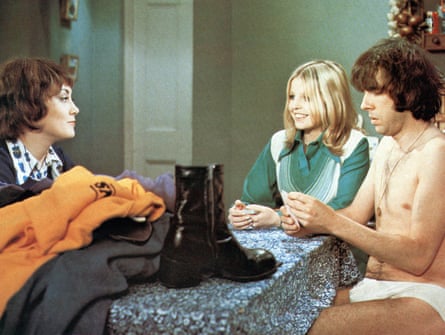 Three 1970s people playing cards – he is stripped down to his pants