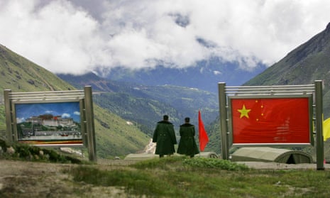 Chinese army officers stand on China’s side of the international border at Nathu La Pass, in northeastern Indian state of Sikkim.
