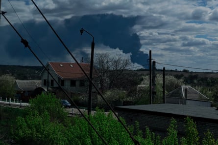 Black smoke rising into the sky is seen above the city on 25 April in Dnipro, Ukraine