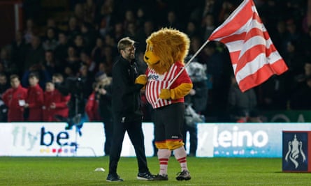 Jürgen Klopp and Grecian the Lion on the pitch at St James Park