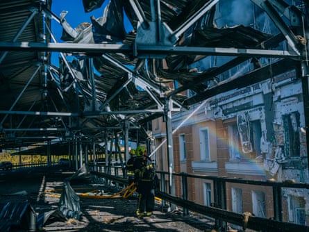 Firefighters working at the site of a Russian drone strike on Kyiv business centre