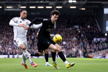 Archie Gray of Tottenham Hotspur is challenged out wide.