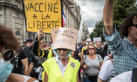 Protesters in Paris march against the French government’s ‘health pass’ requiring proof of vaccination against Covid-19 or a negative test result to visit leisure and cultural venues.