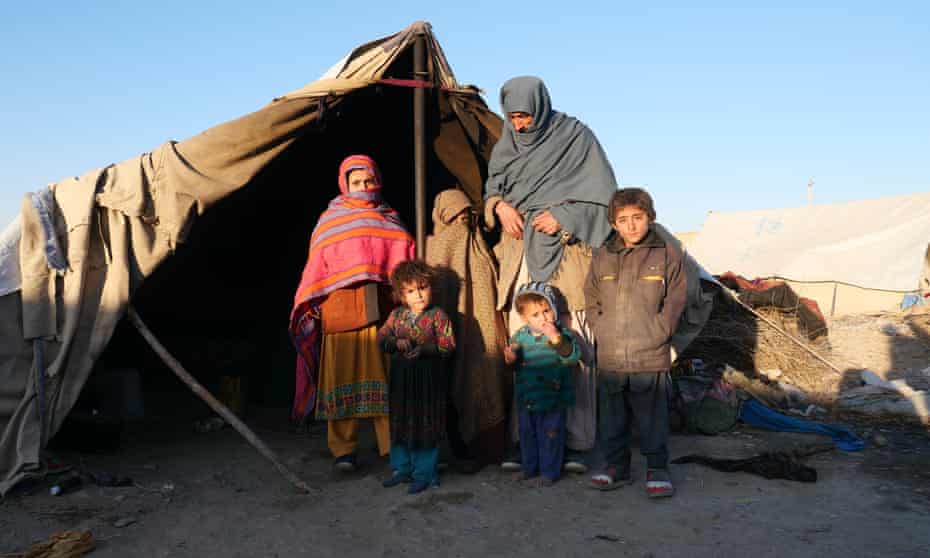 Qayoom and his children outside the tent they now call home. Their village was captured by the Taliban.