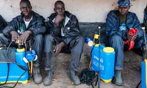 Ugandan soldiers rest after spraying insecticide