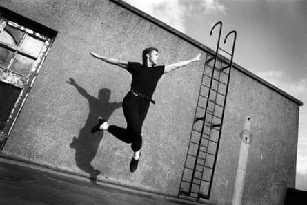 Michael Flatley leaps mid air on a roof top