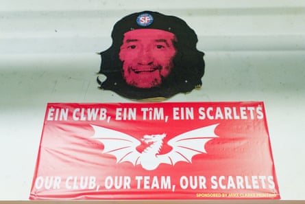 A picture of the former player Ray Gravell, in the likeness of Che Guevara, on the wall of the Tanner Banc Bar above a flag that says: 'Our club, our team, our Scarlets' in English and Welsh