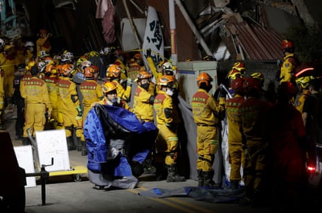 Firefighters prepare to move victims’ bodies outside a collapsed building during a rescue operation following an earthquake in Hualien.