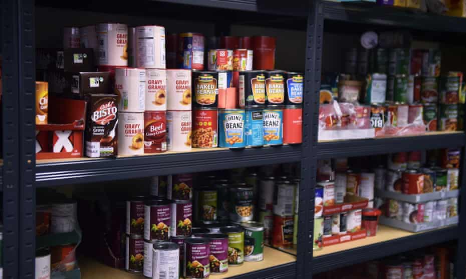 Tins of food on the shelves at the Tri Service Support Centre food bank in Newcastle-under-Lyme, England. 