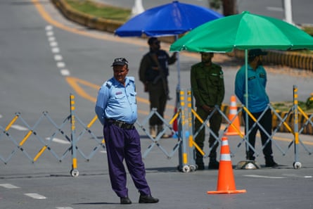 Police officers stand guard at a checkpoint in Islamabad