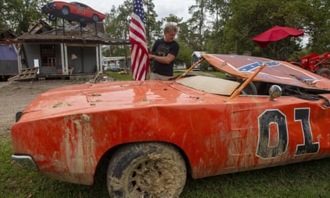 Actor John Schneider, who starred in the television show The Dukes of Hazzard, checks on one of his General Lee cars.