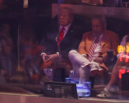 Trump sitting with his hands touching and his eyes closed