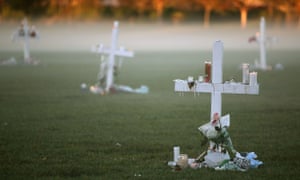Candles and crosses left after a vigil for victims of the mass shooting at Marjory Stoneman Douglas high school in Parkland, Florida.