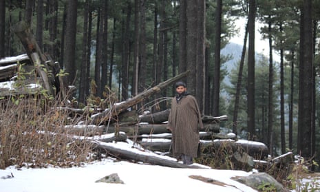 Abdul Aziz stands with the rubble of his forest hut in Khatana Ludro.
