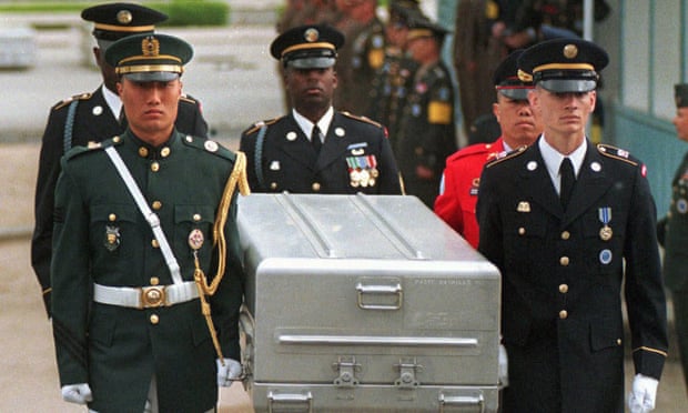 In this May 1999 photo, UN honour guards carry a casket containing remains of US soldiers killed in Korean war after they were returned from North Korea.