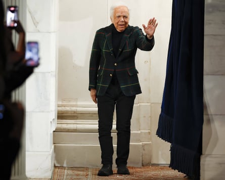 Ralh Lauren tartan jacket and black trousers waves to the audience