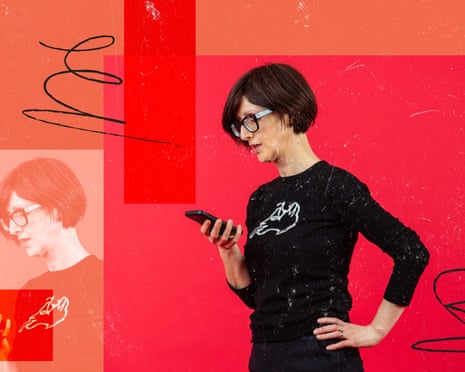 Emma Beddington standing up, looking at her phone