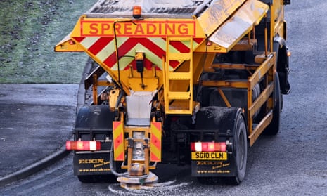 A gritter lorry treats an icy suburban road in Dalgety Bay, Scotland