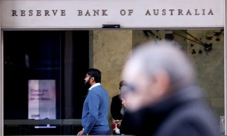 Pedestrians walk past the Reserve Bank of Australia in Sydney.