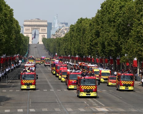 Members of the Paris Fire Brigade with their vehicles take part in the Bastille Day military parade on Champs-Elysees Avenue, in Paris, France.