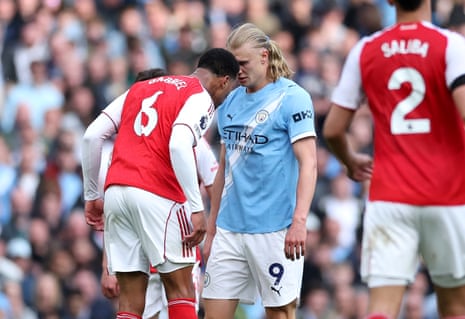 Gabriel of Arsenal clashes with Erling Haaland of Manchester City.