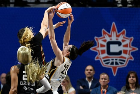Connecticut guard Rachel Banham (1) blocks a shot attempt by Indiana guard Caitlin Clark (22) during the second quarter.