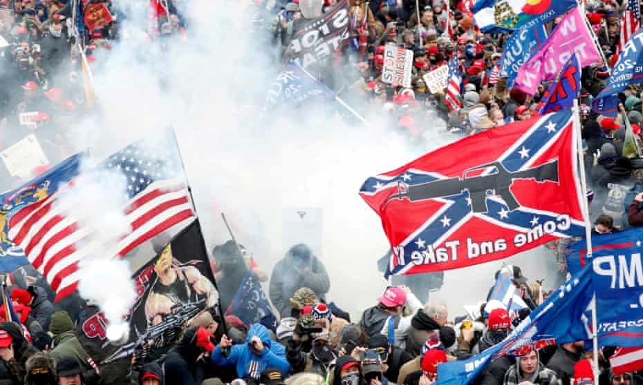 Protesters, with one wielding a Confederate battle flag that reads ‘Come and Take It,’ clash with police at the US Capitol on 6 January 2021.